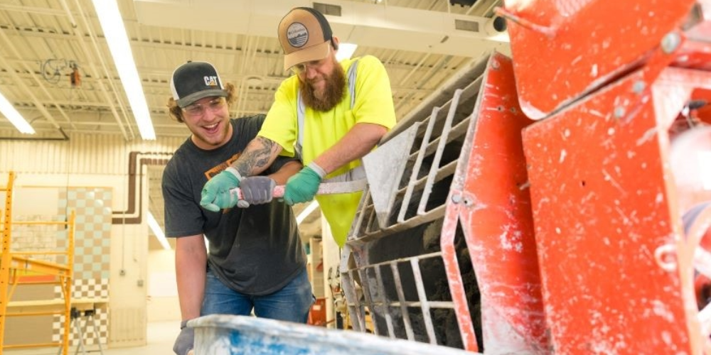 Two apprentices in a training facility.